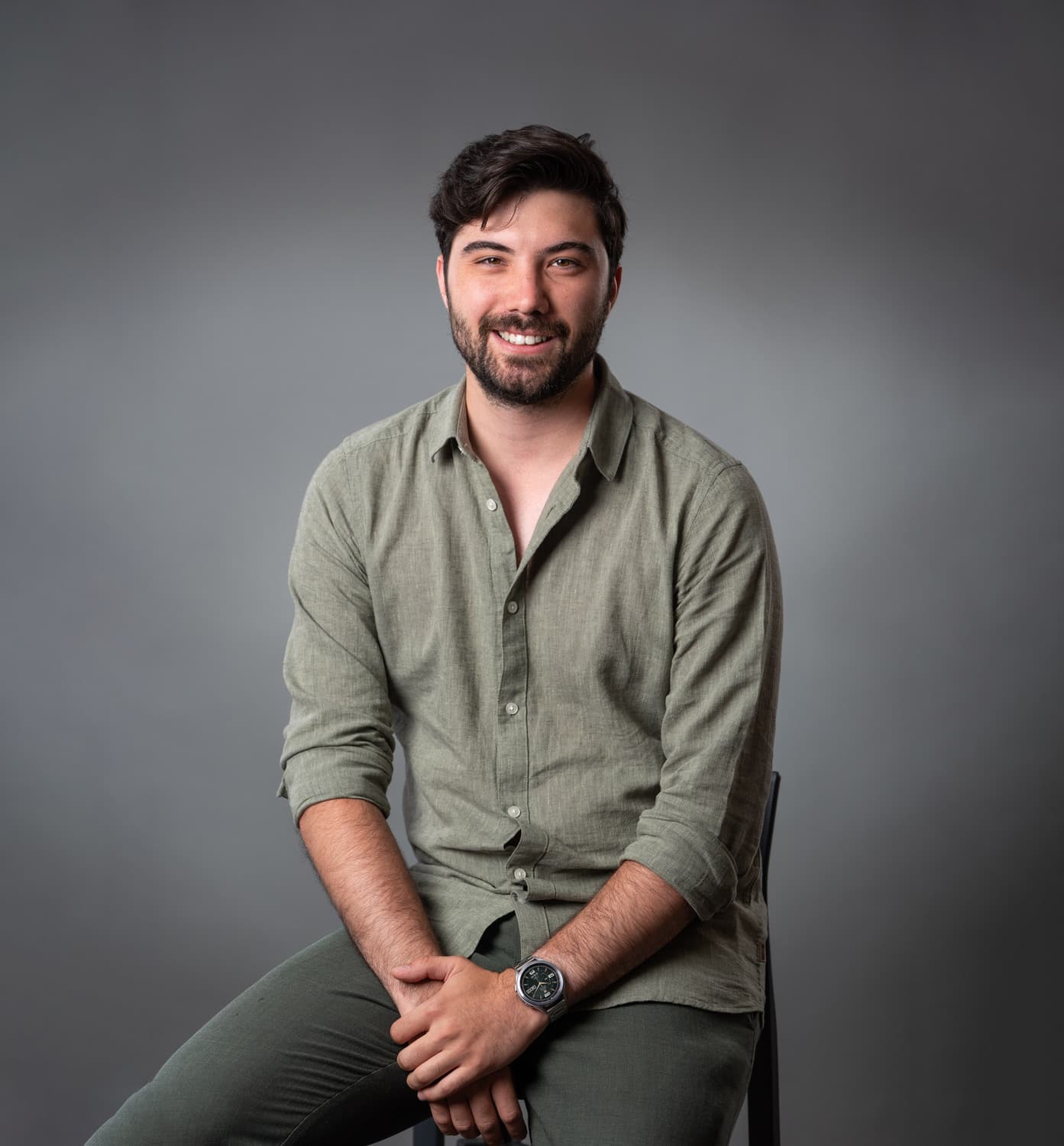 Portrait of Ivan Marić, smiling, in an olive shirt.